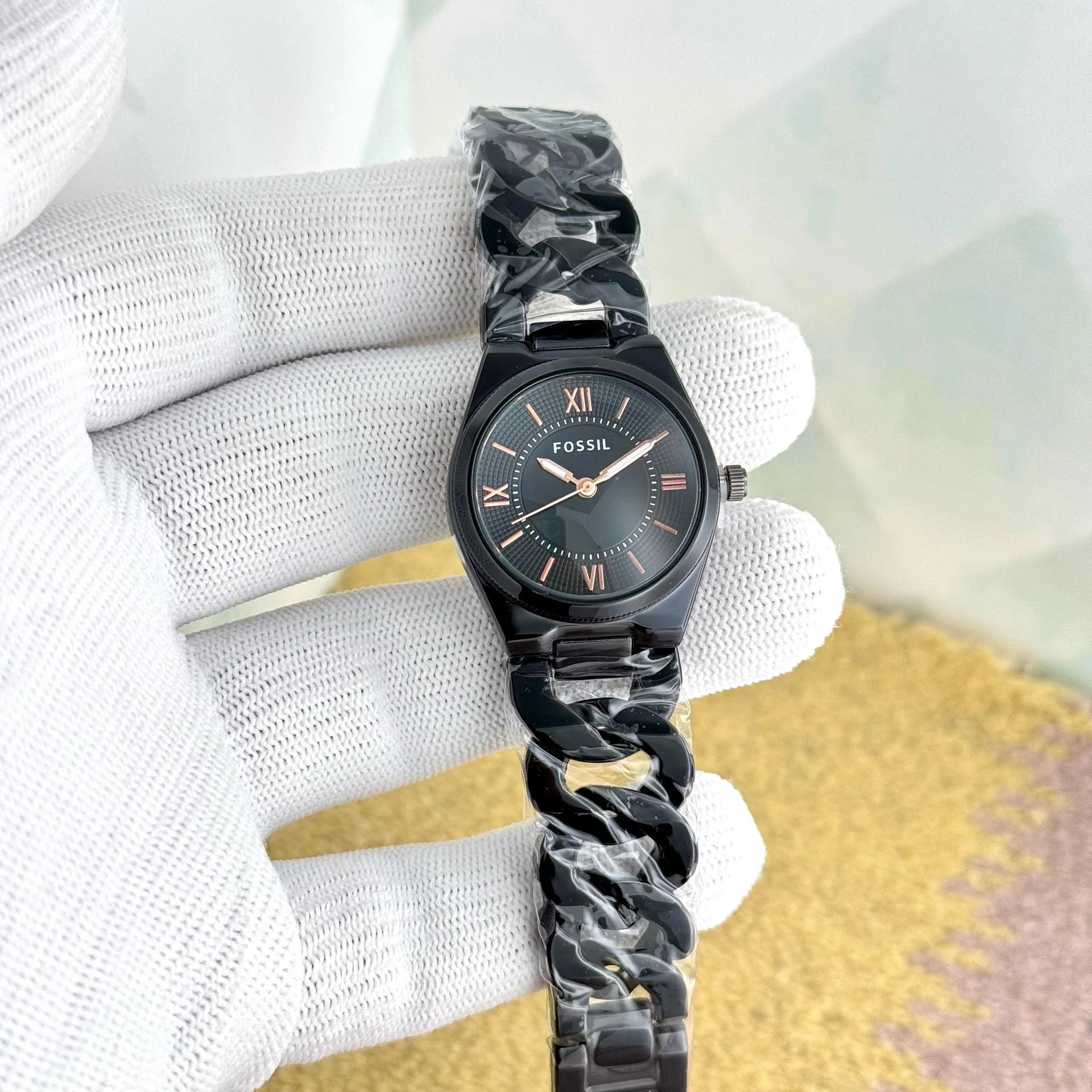 black Fossil watch with a link chain bracelet.