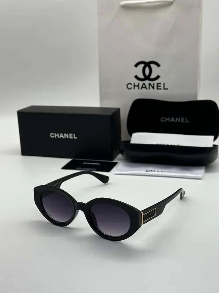 Chanel oval sunglasses in black acetate with brown gradient lenses.