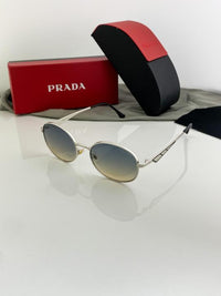 Prada unisex oval silver sunglasses with yellow standard lenses.