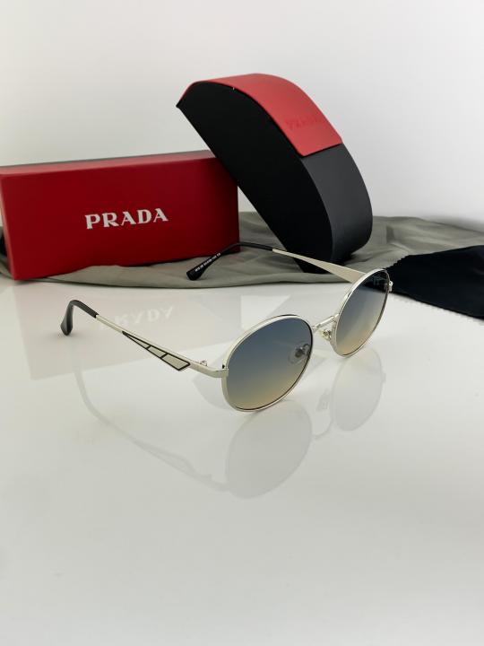 Prada unisex oval silver sunglasses with yellow standard lenses.