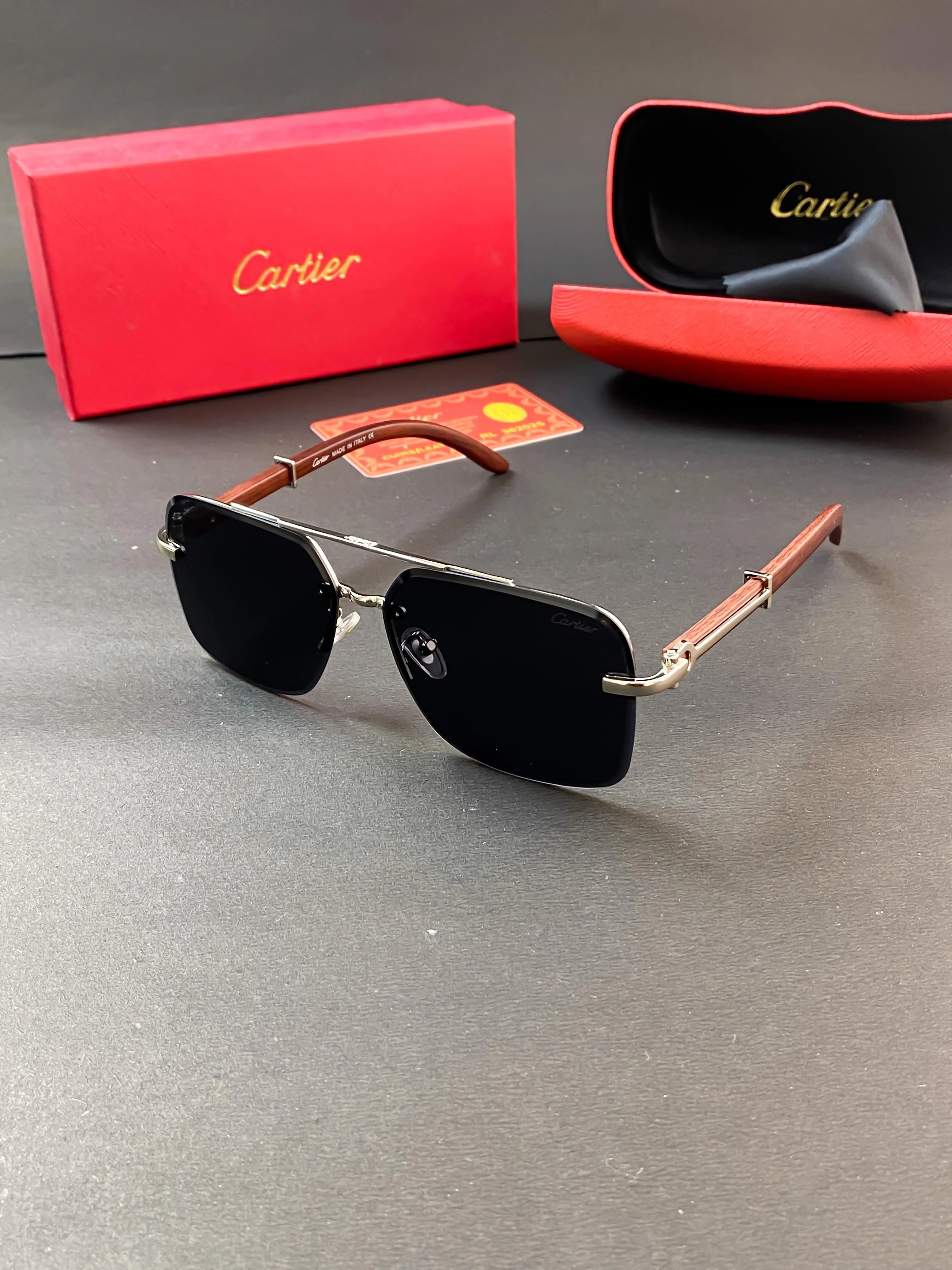 Cartier sunglasses with a silver-tone metal frame and brown wood arms.